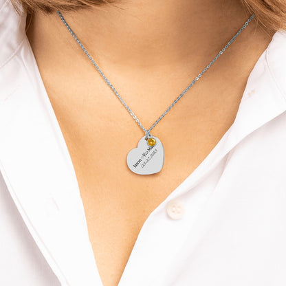 Stainless steel engraved heart necklace worn over a white shirt