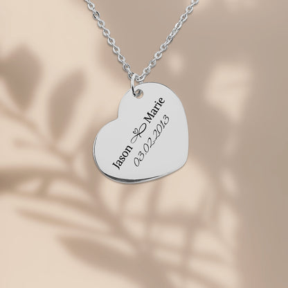 Stainless steel heart pendant engraved with two names and a date